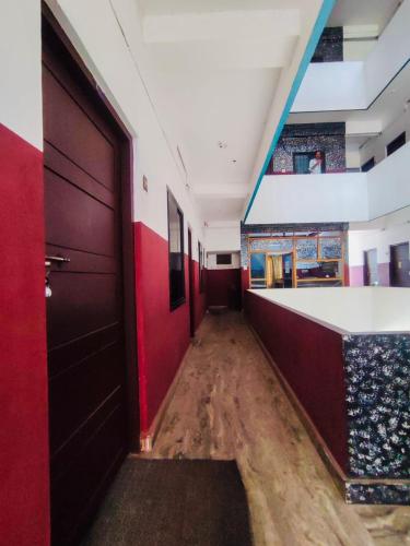 a corridor of a room with red and blue walls at Omega Tourist Home in Trichūr