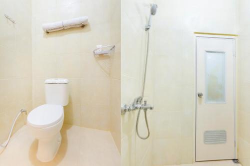 a bathroom with a toilet and a shower at Hotel O Yogyakarta near Universitas Gadjah Mada formerly Sellinas Guesthouse in Yogyakarta