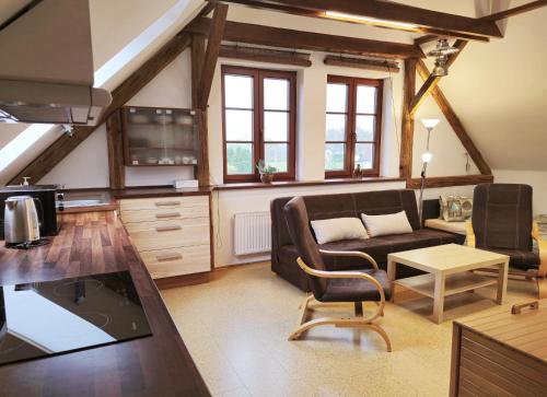 a living room with a couch and a table at Ubytování U MAXÍKA in Suchdol nad Lužnicí