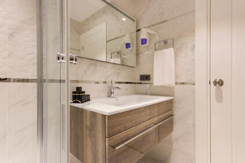 a bathroom with a sink and a shower at Dencity Hotels & Spa in Istanbul