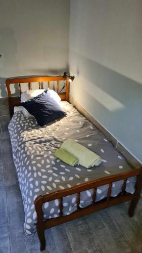 a bedroom with a bed with a wooden frame at Les Gites de la Renardière in Gueures