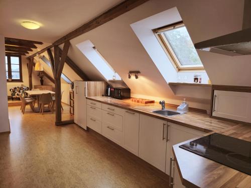 a large kitchen with a sink and a window at Ubytování U MAXÍKA in Suchdol nad Lužnicí