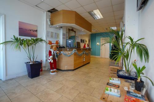 an office with a teddy bear standing at a counter at OYO Shanklin Beach Hotel in Shanklin