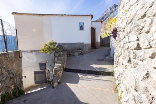 an alley between two stone buildings with a doorway at Estate4home - Casa Satriano in Positano