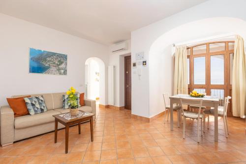a living room with a couch and a table at Estate4home - Casa Satriano in Positano