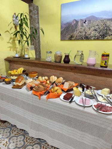 a table with a buffet of food on it at Pousada Campestre Cunha-SP in Cunha