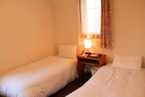 Una cama o camas en una habitación de 彩の宿楓泉