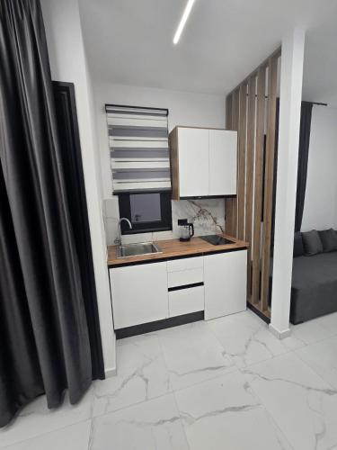 a kitchen with a desk with a computer on it at Elite Inn in Vlorë