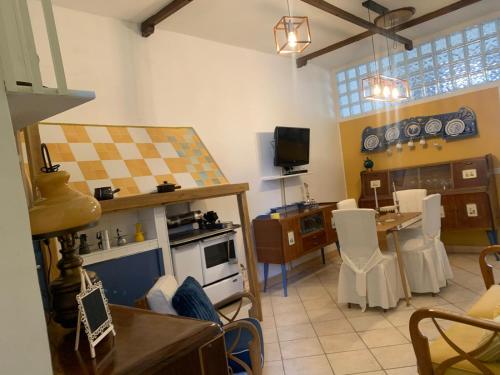 a living room with a kitchen and a dining room at I Colori nel Castello in Capranica