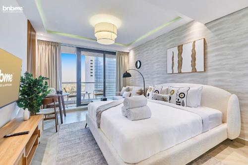 a bedroom with a large bed and a table with a desk at bnbmehomes - Gold crest views 2 in Dubai
