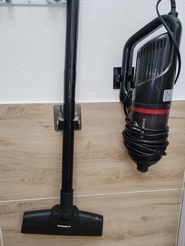 a black iron is hanging on a wall at CASA FLORIS in Tertenìa