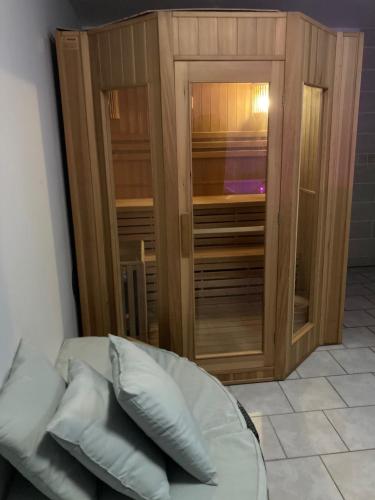 a couch sitting in front of a wooden cabinet at La marine D'opale in Ambleteuse