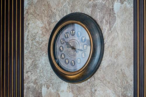 a clock sitting on top of a table at 1BR The Golden Souq by Blue Cloud Holidays in Sharjah Intl