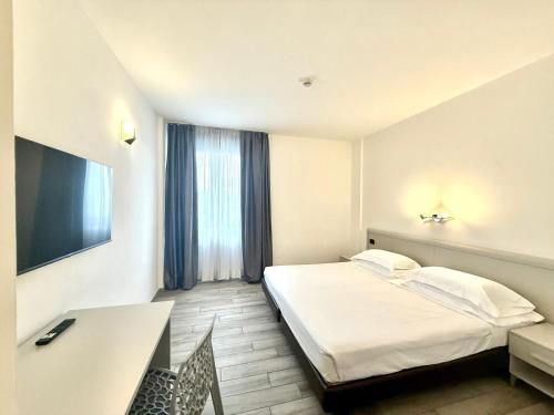 a hotel room with a bed and a desk at Toscana Ambassador in Poggibonsi