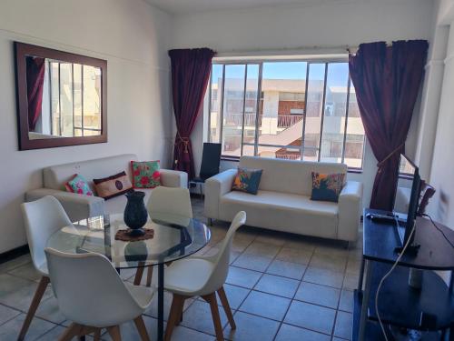 a living room with a couch and a table and chairs at 406 Seabrook in Margate