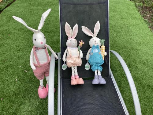 a group of three stuffed rabbits sitting on a skateboard at Relax Apartman in Sümeg