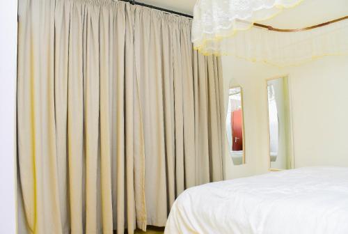 Ένα ή περισσότερα κρεβάτια σε δωμάτιο στο LUKDESI HOMES SOUTH b, NAIROBI