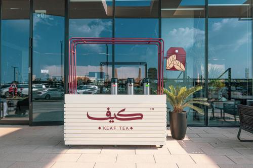 a sign in front of a building with a water taxi at 1BR The Mocha house by Blue Cloud Holidays in Sharjah Intl
