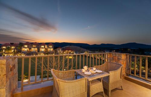 a patio with a table and chairs on a balcony at Sajjan Bagh Resort Kumbhalgarh in Kumbhalgarh