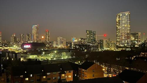 a view of a city at night with buildings at Sunset Heights Bright 2BR with City Views and Free Parking in London