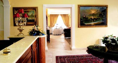 a living room with a kitchen and a dining room at D'Angelo Palace Hotel in Mazara del Vallo