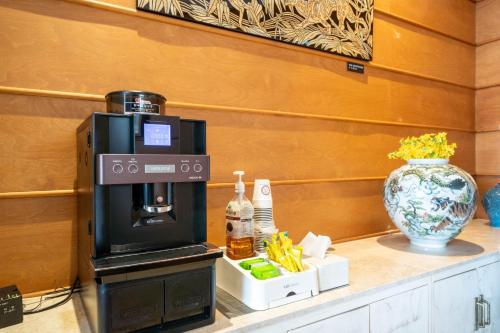 a coffee machine sitting on top of a counter at Mini Hotel in Jincheon