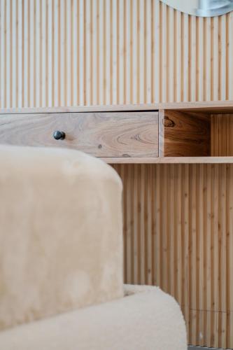 a white wedding cake sitting on top of a wooden shelf at 1BR Exclusive Apartment - Charisma in Sharjah Intl