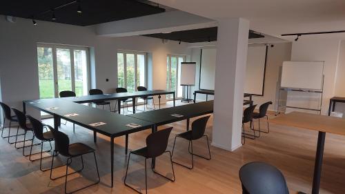 a conference room with tables and chairs and a whiteboard at Mariandl am Meer in Binz