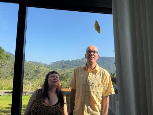 a man and a woman standing in front of a window at Hanthana Heritage in Kandy