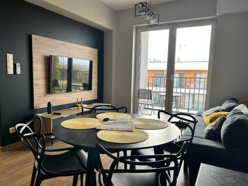 a living room with a table and chairs and a couch at Apartament No82 Yellow Holiday Home Zator in Zator