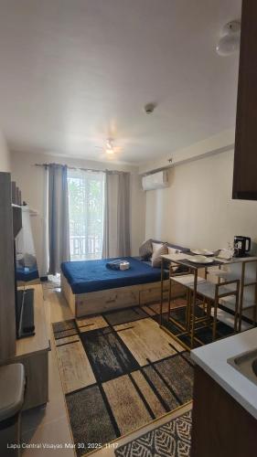 a living room with a bed and a table at Be Housed Studio Bldg 302 in Lapu Lapu City