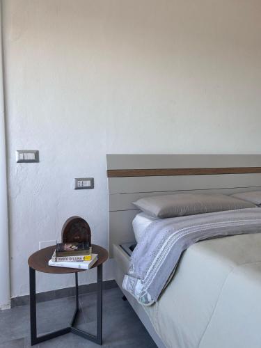 a bedroom with a bed and a table with a book at Piccolo attico a Prato in Prato