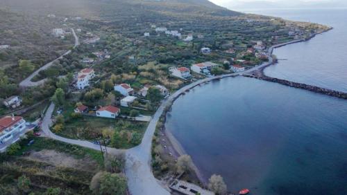 an aerial view of a small island in the water at stamatiou in Methana