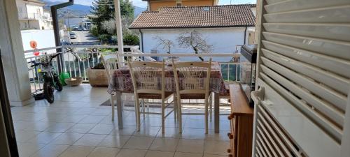 a porch with chairs and a table on a balcony at Casa vacanze di Elisa in Caniparola di Fosdinovo