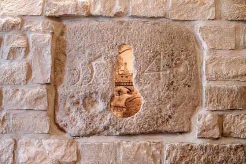 a stone wall with a picture of a tower at Löwen Hotel & Restaurant in Marktbreit