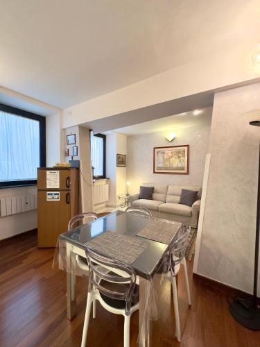 a living room with a table and chairs and a couch at Belvedere House in Castel Gandolfo