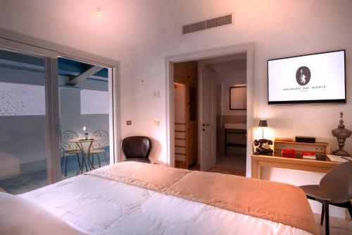 a bedroom with a bed and a television on a wall at Hotel Casa Bianconi in Norcia