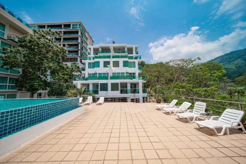a group of chairs sitting on a patio in front of a building at A New Experience of Private Vacation and Work in Patong in Patong Beach