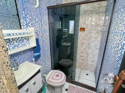 a bathroom with a shower and a toilet and a sink at Sun House WSL in Saquarema