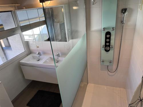 a bathroom with a shower and a sink at Duinengolf in Middelkerke