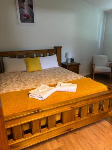 a bedroom with a bed with two towels on it at Sage Cottage in Cowaramup