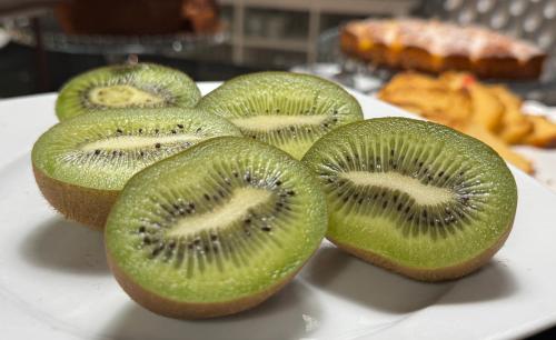 a group of kiwi slices on a white plate at Hotel Alendouro in Macedo de Cavaleiros