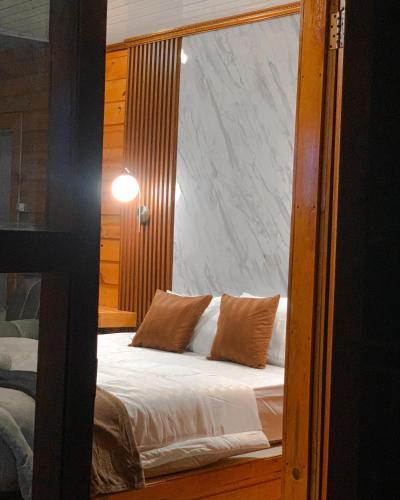 a reflection of a bed in a mirror at Avana Cabin Sikunir Lake View in Kejajar