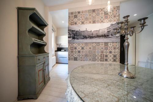 a kitchen with a glass table in a room at La Martinella by Palazzo Bianchini in Siena