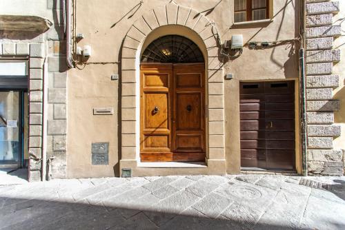 a wooden door on the side of a building at La Martinella by Palazzo Bianchini in Siena