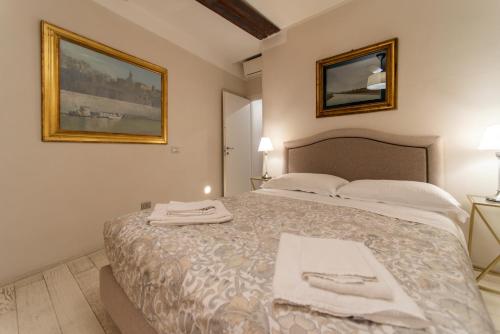 a bedroom with a bed with two towels on it at La Martinella by Palazzo Bianchini in Siena