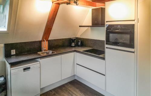 a small kitchen with white cabinets and a sink at 3 Bedroom Beautiful Home In Gramsbergen in Gramsbergen