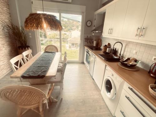 a kitchen with a table and a sink and a stove at KIPOS-SS residences in Dassia