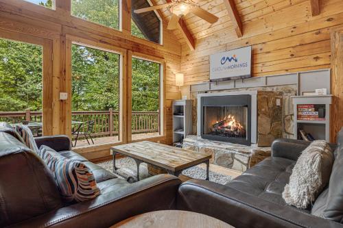 a living room with couches and a fireplace at Red Wolf by Carolina Mornings in Fletcher