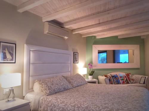 a bedroom with a bed and a window at Villa Khepri in Porto Rotondo